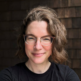 Kate, a white woman with brown hair and glasses